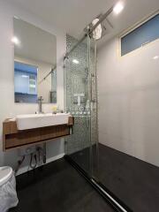 Modern bathroom with shower and wooden accents