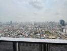 Expansive cityscape view from a high-rise balcony