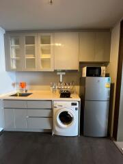 Modern compact kitchen with appliances and white cabinetry