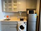 Modern compact kitchen with appliances and white cabinetry