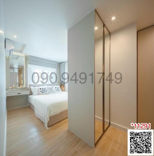 Spacious modern bedroom with built-in wardrobes and hardwood floors