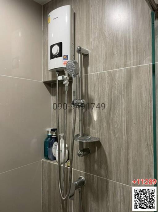 Modern wall-mounted gas water heater and shower system in a tiled bathroom