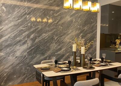 Modern dining room with marble wall and elegant lighting
