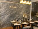 Modern dining room with marble wall and elegant lighting
