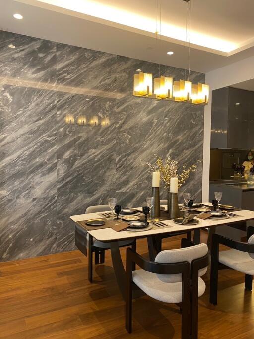 Modern dining room with marble wall and elegant lighting