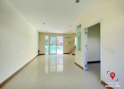 Spacious and Bright Living Room with Tile Flooring and Easy Access to the Stairs