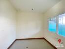 Empty bedroom with natural light and white walls