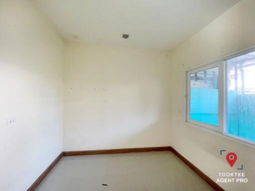 Empty bedroom with natural light and white walls