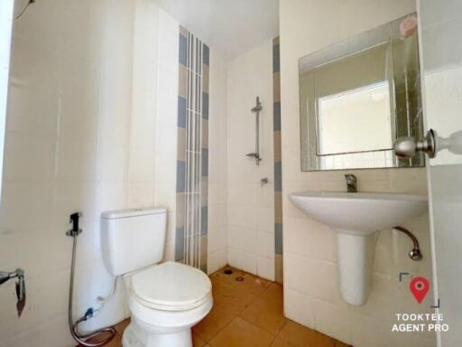 Bright bathroom with white fixtures and a shower