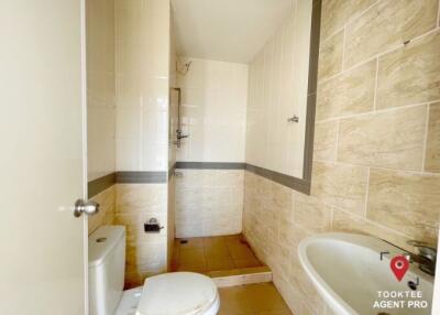 Bright clean bathroom with tiled walls and flooring
