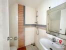 Compact bathroom with white tiling and shower