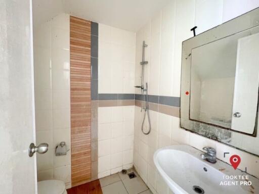 Compact bathroom with white tiling and shower