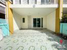 Exterior front view of a modern house with patterned tile flooring