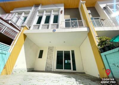 Modern two-story building with balcony and external stairs