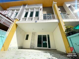 Modern two-story building with balcony and external stairs