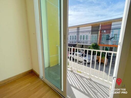 Bright balcony with sliding glass door and view of the neighborhood