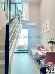 Modern home interior with staircase, dining area, and bright open door