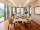 Elegant dining room with a large table set for a meal, floor-to-ceiling windows, and hardwood floors