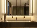 Modern bathroom with large mirror and warm lighting