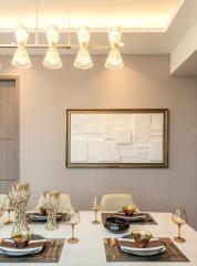 Elegant dining room with modern lighting and artwork