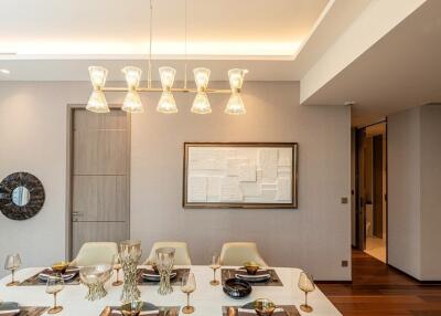 Modern dining room with elegant table setup and pendant lighting