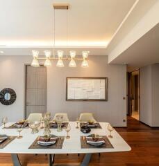 Modern dining room with elegant table setup and pendant lighting