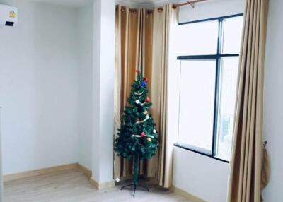 Spacious and bright living room with a Christmas tree by the window