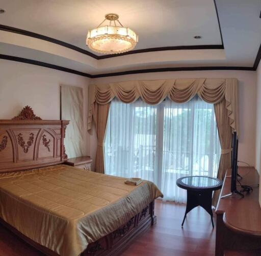 Elegant master bedroom with traditional furniture and ample lighting