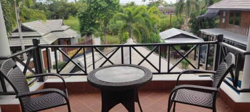 Spacious balcony with outdoor seating and a scenic view of the surrounding greenery