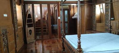 Elegant wooden bedroom interior with crafted wardrobe and stairs