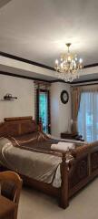 Elegant and spacious bedroom with classic furniture and chandelier