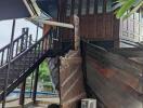 Exterior view of a building featuring stairs and a wooden entrance door