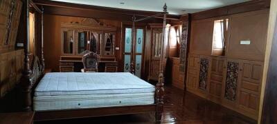 Spacious bedroom with traditional wooden furniture and wardrobe