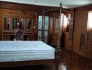 Spacious bedroom with traditional wooden furniture and wardrobe