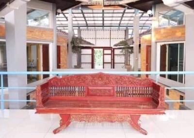 Spacious and brightly lit indoor atrium with traditional red bench and elegant architecture