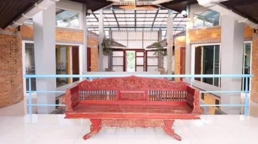 Spacious and brightly lit indoor atrium with traditional red bench and elegant architecture