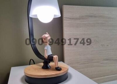 Stylish bedside lamp on a nightstand with decorative figurine