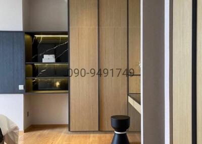 Modern bedroom entrance with a wooden door and hardwood floor