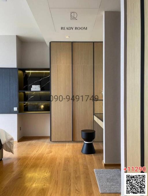Modern bedroom entrance with a wooden door and hardwood floor