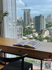 City view from high-rise apartment with desk and book