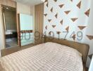 modern bedroom with geometric wallpaper design and en-suite bathroom