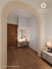 Elegant bedroom with a wooden floor, makeup vanity, and arched doorway