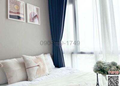 Contemporary bedroom with wall art and natural light