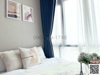 Contemporary bedroom with wall art and natural light