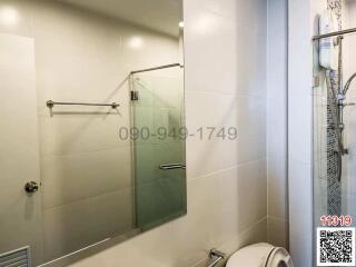 Modern bathroom interior with glass shower and tiled walls