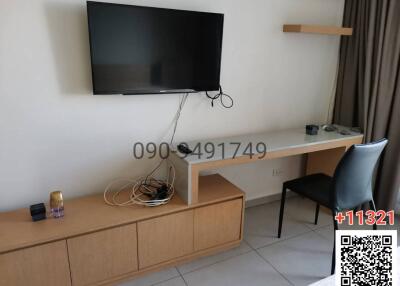 Modern living room interior with wall-mounted TV and wooden furniture