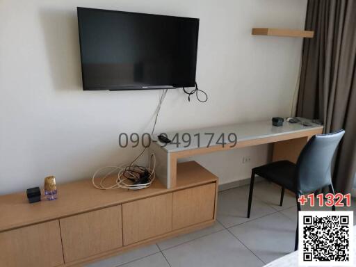 Modern living room interior with wall-mounted TV and wooden furniture