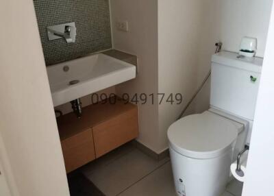 Modern bathroom with sink, faucet, and toilet