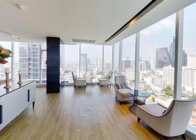 Spacious living room with modern furniture and city skyline view