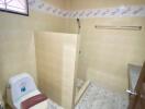 Compact bathroom with tiled walls and essential fixtures